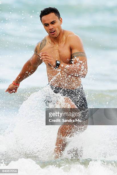 Rudi Wulf runs through the surf during a Blues Super 14 pre-season training session at Mairangi Bay Surf Club on December 19, 2008 in Auckland, New...