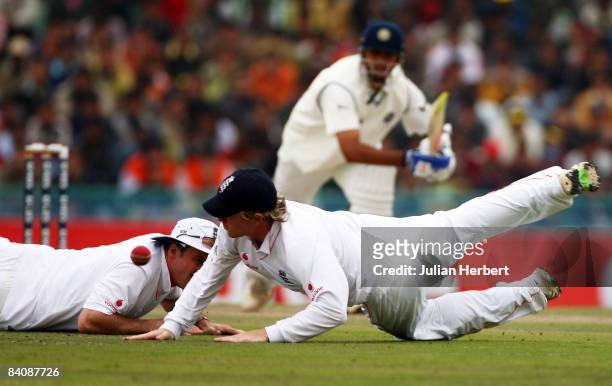 Rahul Dravid drives the ball past Ian Bell of England as he dives for the ball during day 1 of the Second Test Match between India and England at the...