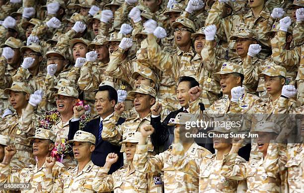 South Korean president Lee Myung-Bak and prime minister Han Seung-Soo celebrate with soldiers during a welcome home ceremony on December 19, 2008 in...