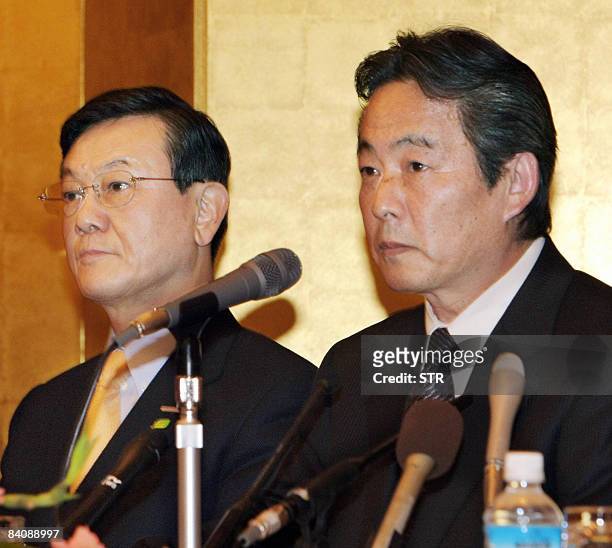 Japan's electronics giant Panasonic president Fumio Otsubo and Sanyo president Seiichiro Sano listen during a press conference in Osaka, western...