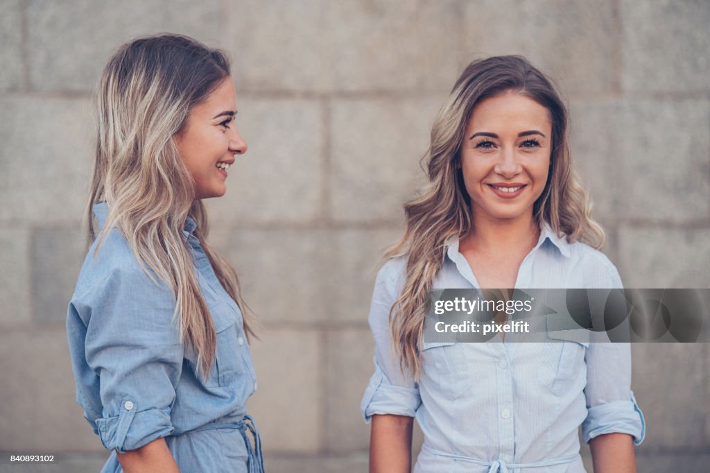 Identical twins sisters - front and side view