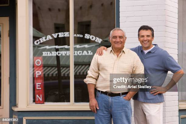 father and son in front of family business - family business generations stock pictures, royalty-free photos & images