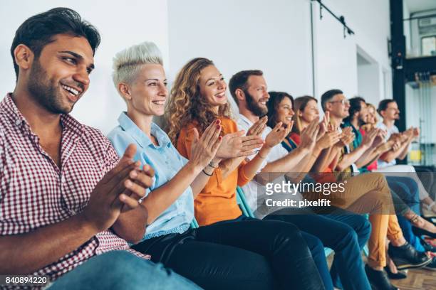 large group of people applauding - applauding stock pictures, royalty-free photos & images