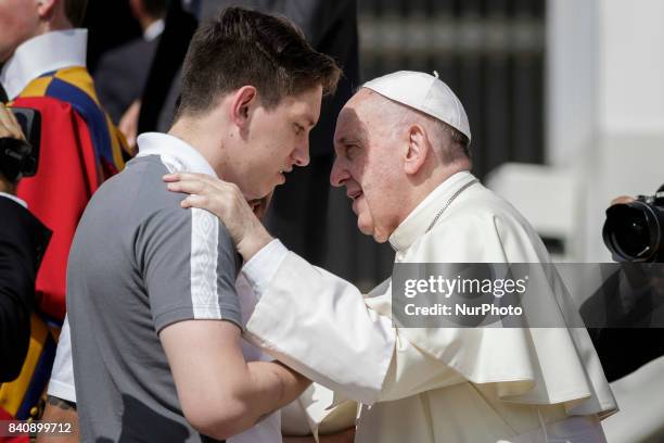 Pope Francis talks with soccer players Jackson Follmann, who survived when the plane carrying Brazilian soccer team Chapecoense crashed, during his...