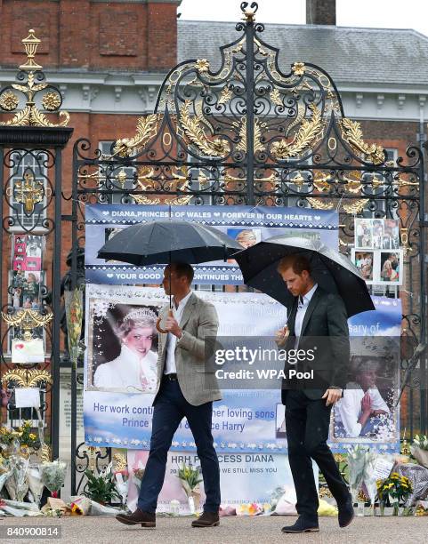 Prince William, Duke of Cambridge and Prince Harry are seen during a visit to The Sunken Garden at Kensington Palace on August 30, 2017 in London,...