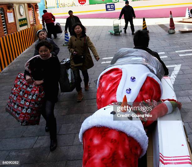 Man delivers Christmas decorations at a market on December 19, 2008 in Beijing, China. A large number of Christmas decorations destined to the...