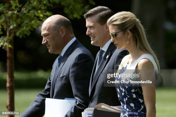 National Economic Council Director Gary Cohn, White House Staff Secretary Rob Porter and Ivanka Trump walk across the South Lawn before departing the...