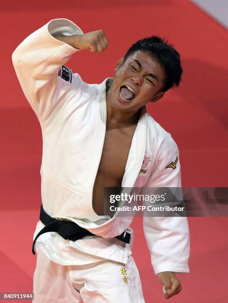 Japan's Soichi Hashimoto celebrates his victory over Azerbaian's Rustam Orujov after their final in the mens -73kg category at the World Judo...