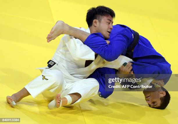 Gold medalist Japan's Soichi Hashimoto competes with Azerbaian's Rustam Orujov during their final in the mens -73kg category at the World Judo...