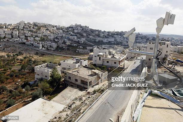 Surveillance cameras are seen on the roof of a disputed house in the divided West Bank city of Hebron on November 21, 2008. Israel beefed up security...