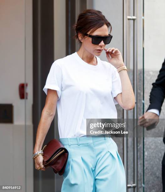 Victoria Beckham out and about in a white shirt and baby blue trousers in New York.