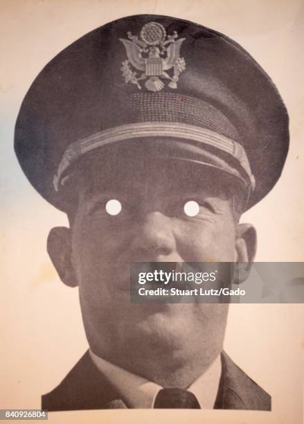 Printed mask with cut out eyeholes of United States Army solider William Calley, convicted of murdering 22 Vietnamese civilians in the My Lai...