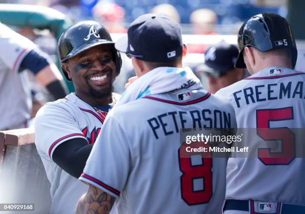 Brandon Phillips of the Atlanta Braves celebrates with Jace Peterson against the Philadelphia Phillies in the top of the first inning after scoring a...