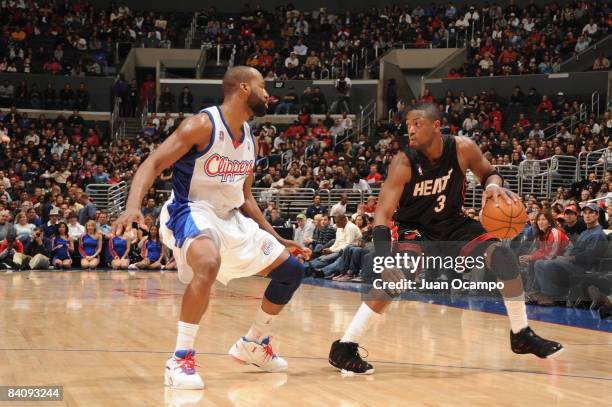 Dwyane Wade of the Miami Heat moves the ball against Baron Davis of the Los Angeles Clippers during the game at Staples Center on November 29, 2008...