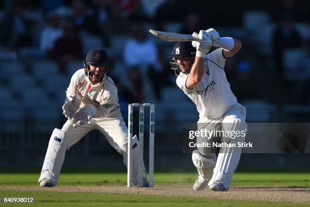 Tim Ambrose of Warwickshire drives the ball during the County Championship Division One match between Lancashire and Warwickshire at Old Trafford on...