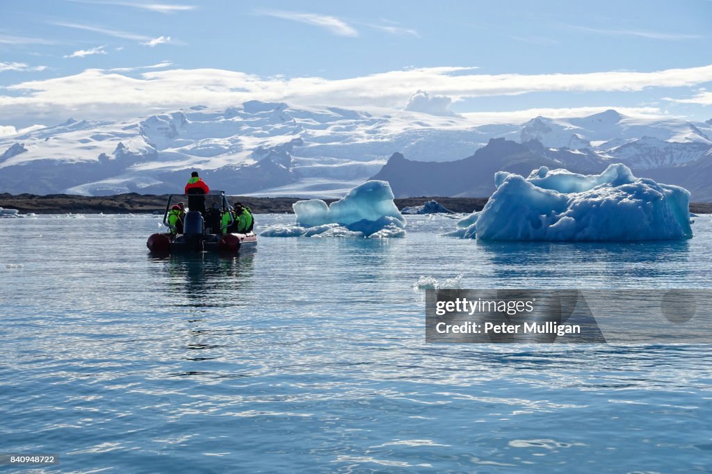 Rigid inflatable boat near icebergs in the glacier lagoon of Jökulsárlón, Iceland