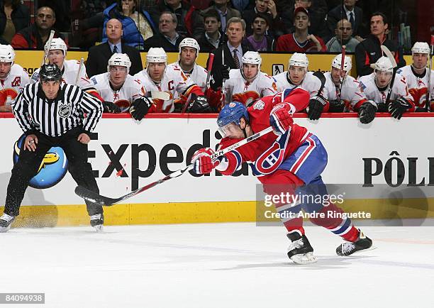 Patrice Brisebois of the Montreal Canadiens shoots the puck against the Calgary Flames at the Bell Centre on December 9, 2008 in Montreal, Quebec,...