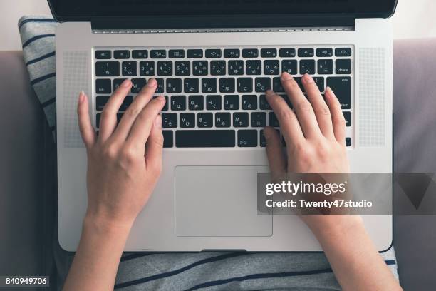 hand typing laptop above view - blogging stock pictures, royalty-free photos & images