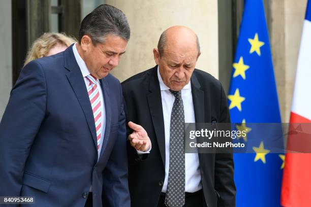 German Vice Chancellor and Foreign Minister Sigmar Gabriel leaves the Elysee presidential Palace with French Foreign Affairs Minister Jean-Yves Le...