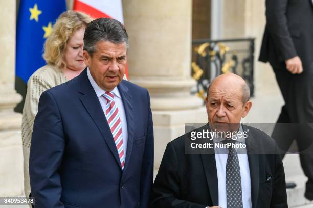 German Vice Chancellor and Foreign Minister Sigmar Gabriel leaves the Elysee presidential Palace with French Foreign Affairs Minister Jean-Yves Le...
