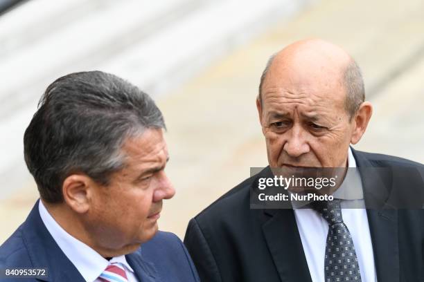 German Vice Chancellor and Foreign Minister Sigmar Gabriel leaves the Elysee presidential Palace with French Foreign Affairs Minister Jean-Yves Le...