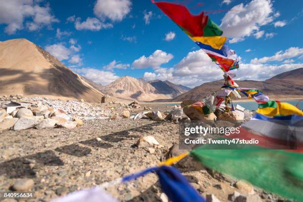colorful prayer flags with motion at pangong lake, ladakh, india. - buddhist flag stock pictures, royalty-free photos & images