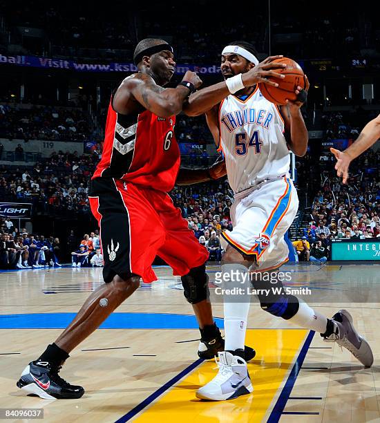 Chris Wilcox of the Oklahoma City Thunder goes to the basket against Jermaine O'Neal of the Toronto Raptors at the Ford Center on December 19, 2008...