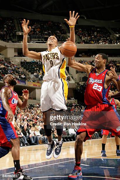 Maceo Baston of the Indiana Pacers looses the ball battling Marcus Camby and Baron Davis of the Los Angeles Clippers at Conseco Fieldhouse on...