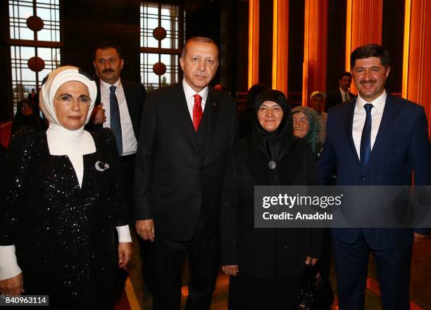 Turkish President Recep Tayyip Erdogan and his wife Emine Erdogan pose with a group of citizens for a photo during a reception for the 95th...