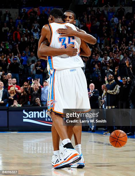 Desmond Mason and Kevin Durant of the Oklahoma City Thunder hug each other after winning the game against the Toronto Raptors at the Ford Center on...
