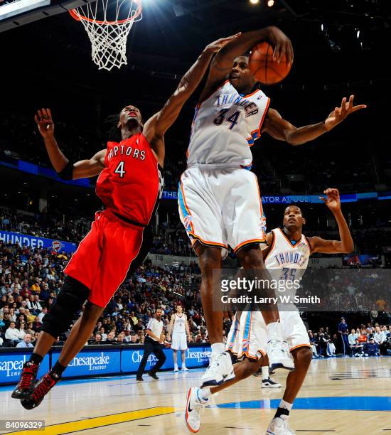 Desmond Mason of the Oklahoma City Thunder grabs a rebound from Chris Bosh of the Toronto Raptors at the Ford Center on December 19, 2008 in Oklahoma...