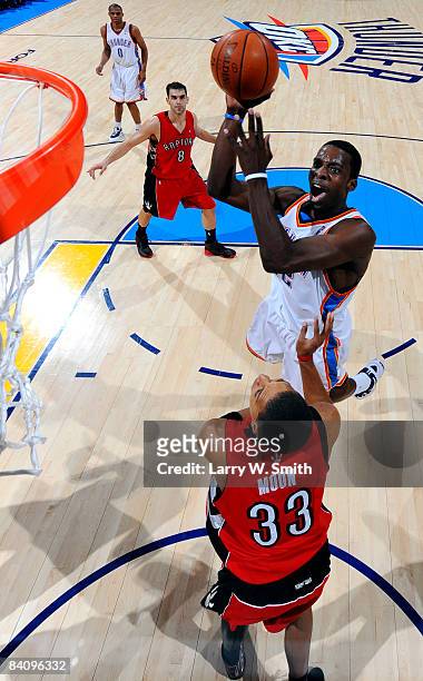 Jeff Green of the Oklahoma City Thunder goes to the basket against Jamario Moon of the Toronto Raptors at the Ford Center on December 19, 2008 in...