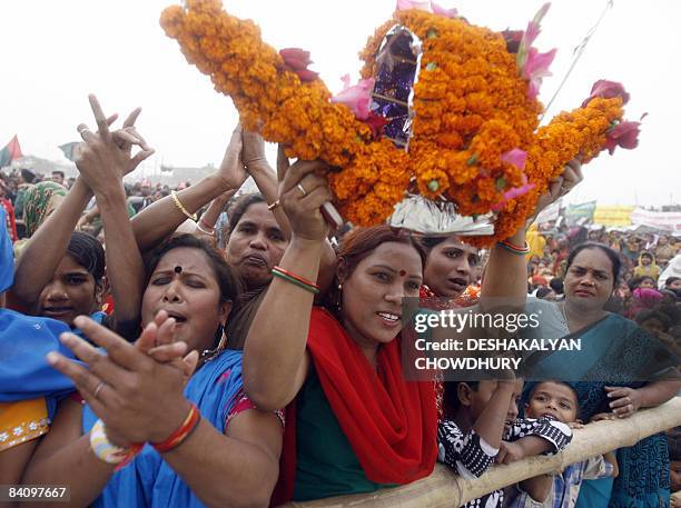 Supporters of Bangladesh's Awami League party hold aloft a boat, the party symbol, during a rally attended by party leader and former Bangladeshi...