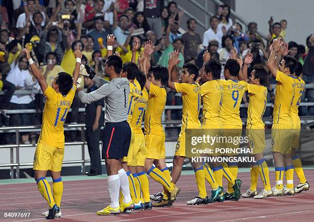 Thai football players celebrate after beating Indonesia during their AFF Suzuki Cup 2008 match at the Rajamangala stadium in Bangkok on December 20,...