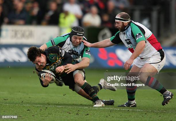 Lee Dickson of Northampton is tackled by Mike Ross during the Guinness Premiership match between Northampton Saints and Harlequins at Franklin's...