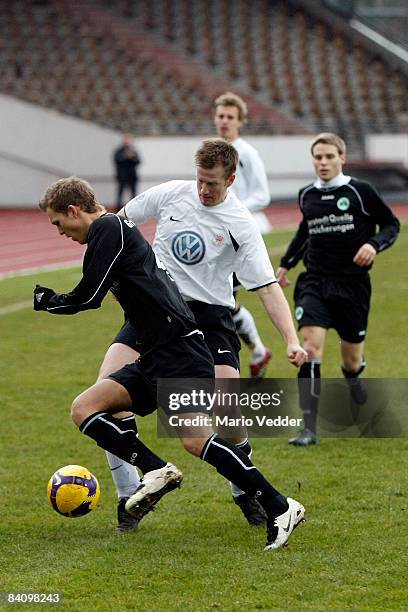 Thorsten Bauer of Hessen Kassel and Fabian Baumgaertel fight for the ball during the regional league match between KSV Hessen Kassel and SpVgg...