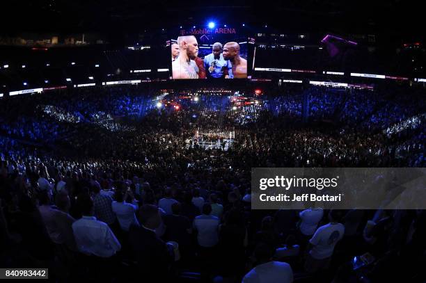 General view shows referee Robert Byrd giving instructions to Floyd Mayweather Jr. And Conor McGregor before their super welterweight boxing match on...