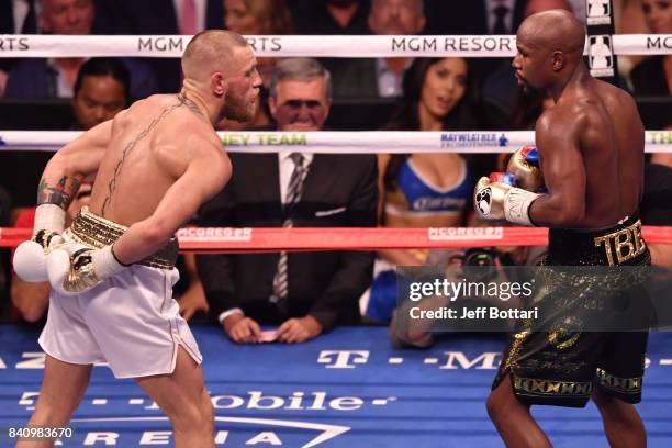 Conor McGregor taunts Floyd Mayweather Jr. By holding his hands behind his back in their super welterweight boxing match at T-Mobile Arena on August...