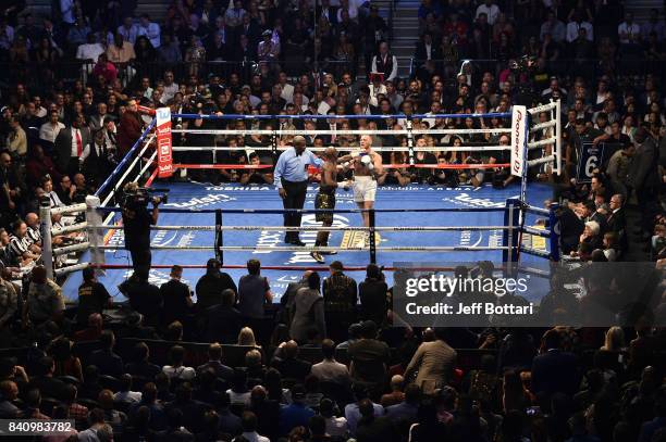Floyd Mayweather Jr. Pushes Conor McGregor after the bell rings in their super welterweight boxing match at T-Mobile Arena on August 26, 2017 in Las...