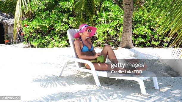 hipster woman sitting and chilling on easy chair on beach, maldives - beach vibes stock pictures, royalty-free photos & images