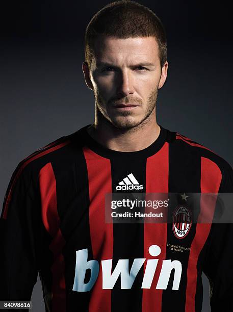 In this handout photo provided by adidas, David Beckham of AC Milan reveals his new number 32 shirt before a press conference to announce the start...