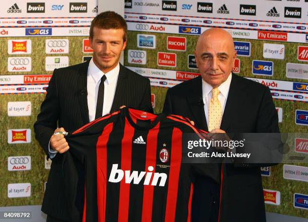 David Beckham stands with Adriano Galliani the Vice President of AC Milan after a press conference at the San Siro Stadium where he signed for AC...