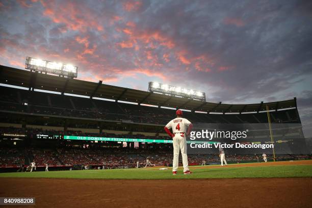 Pitcher Daniel Gossett of the Oakland Athletics pitches to Luis Valbuena of the Los Angeles Angels of Anaheim as first base coach Alfredo Griffin of...