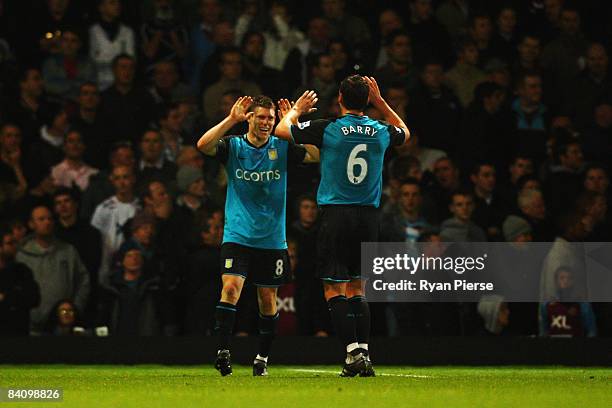 James Milner of Aston Villa celebrates with team mate Gareth Barry after his shot is deflected by Lucas Neill of West Ham United into his own net...