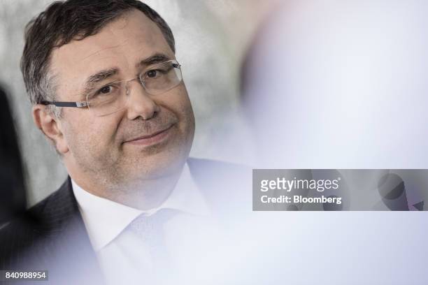 Patrick Pouyanne, chief executive officer of Total SA, listens during a Bloomberg Television interview at the Medef business conference in...