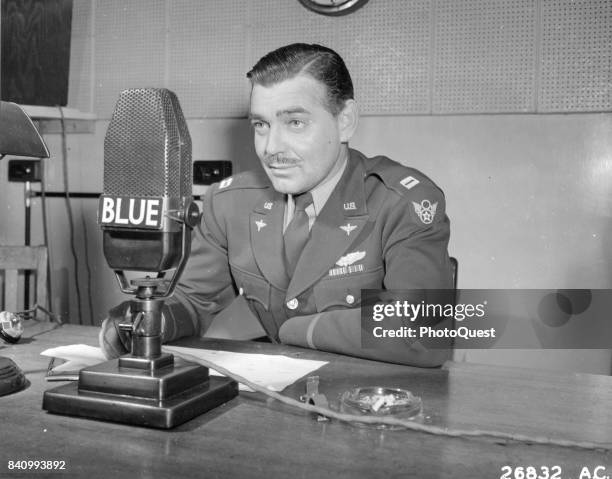 Army Air Corps Capt Clark Gable speaks into a microphone as he urges the purchase of War Bonds in support of the 3rd War Loan Drive program, England,...