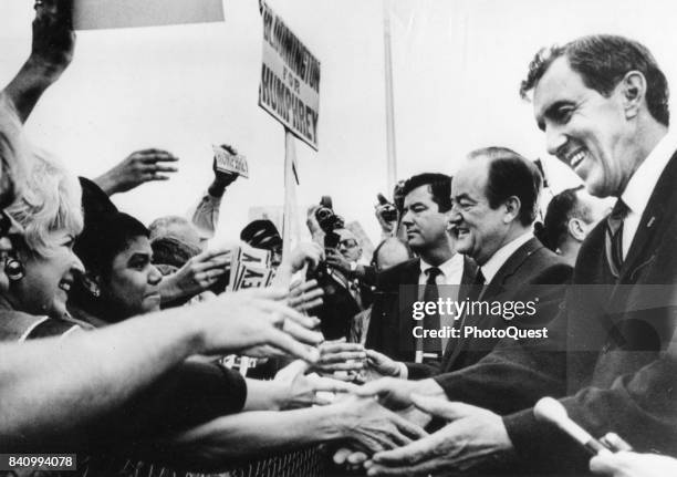 Democratic candidate for President US Vice President Hubert Humphrey and and his running mate Senator Edmund Muskie shake hands with supporters as...