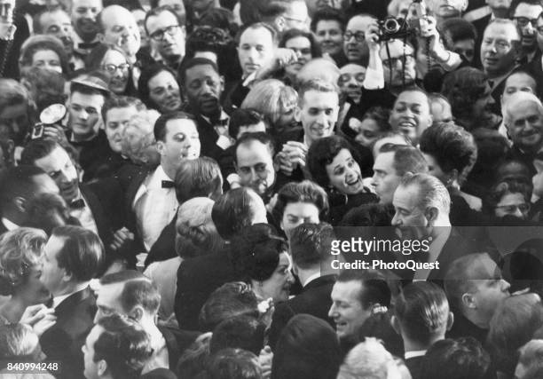 Elevated view of US President Lyndon B Johnson moves among the crowd at one of the five Inaugural Balls held in his honor on the evening of...