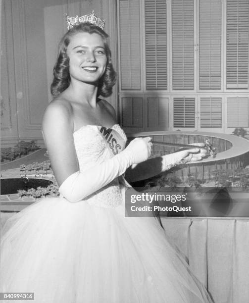 Portrait of Miss America Marilyn Van Derbur as she poses with a model of the United States Pavilion , Denver, Colorado, 1958. She was scheduled to...