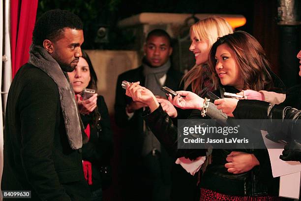 Rapper Kanye West speaks to reporters at Flaunt Magazine's 10th anniversary and annual holiday toy drive at The Wayne Kao Mansion on December 18,...